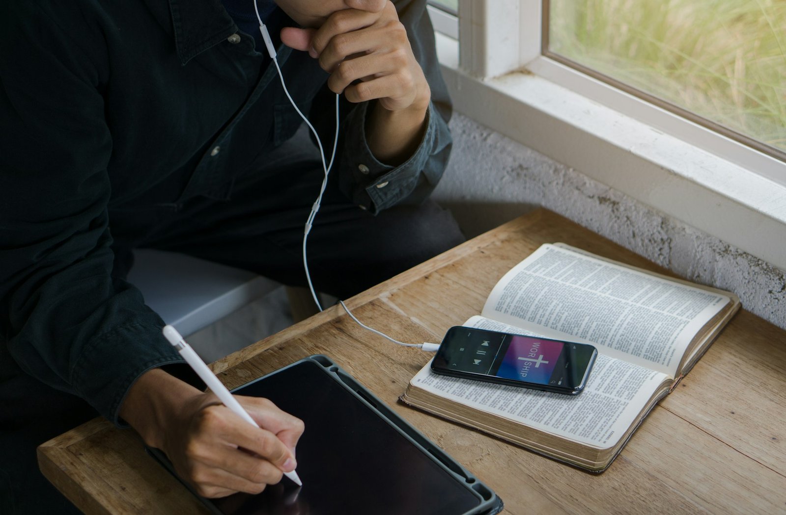 Christian man listen to worship song and praying to GOD with church online Sunday Live Church.